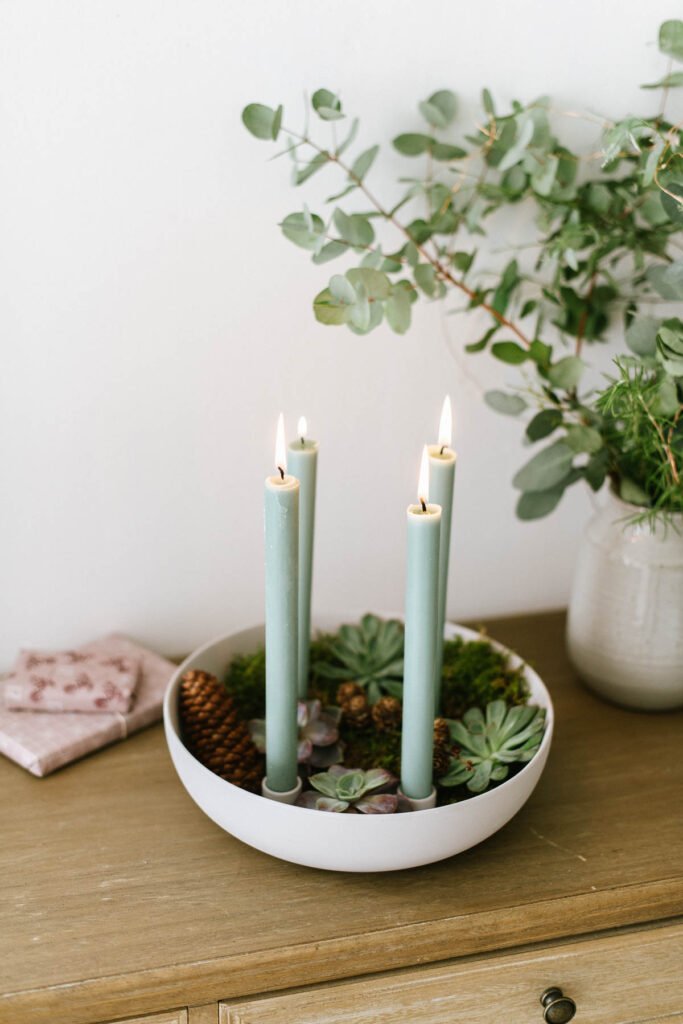Kerzenschale mit Sukkulenten als minimalistischen Adventskranz. Kerzenschale mit natürlichen Materialien füllen und Stabkerzen anzünden.