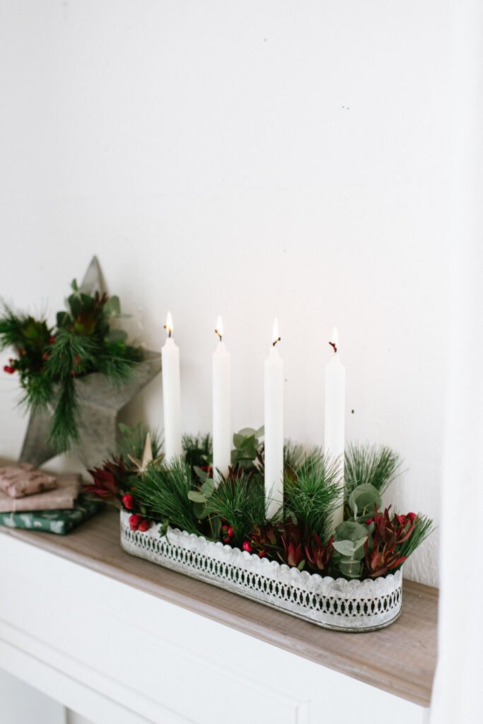 DIY Adventskranz mit Pflanzen für draußen weihnachtlich dekorieren mit grünen Zweigen und Beeren oder Olivenzweigen.
