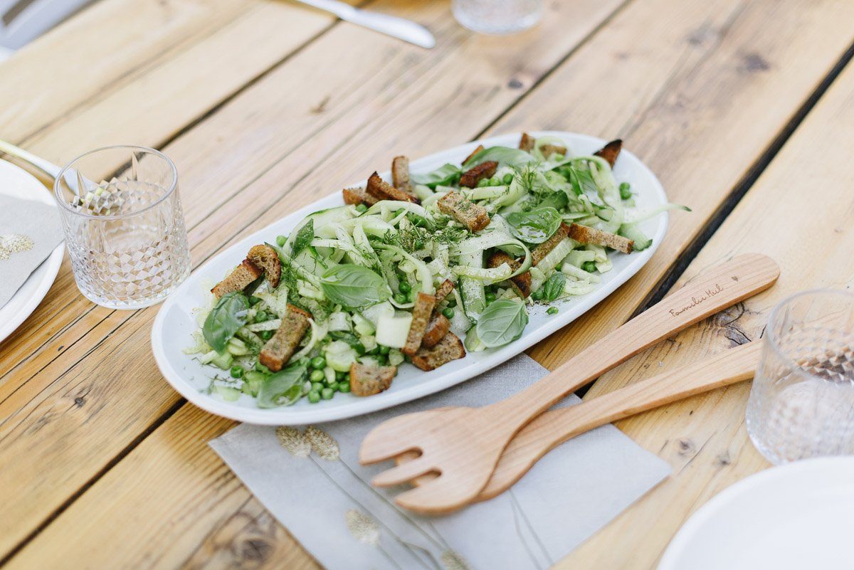 grüner Brotsalat auf einem Holztisch
