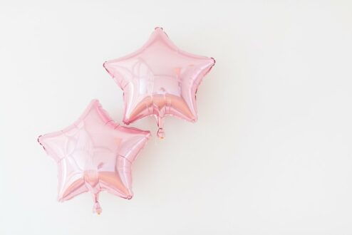 2 rosa Folienballons in Stern-Form
